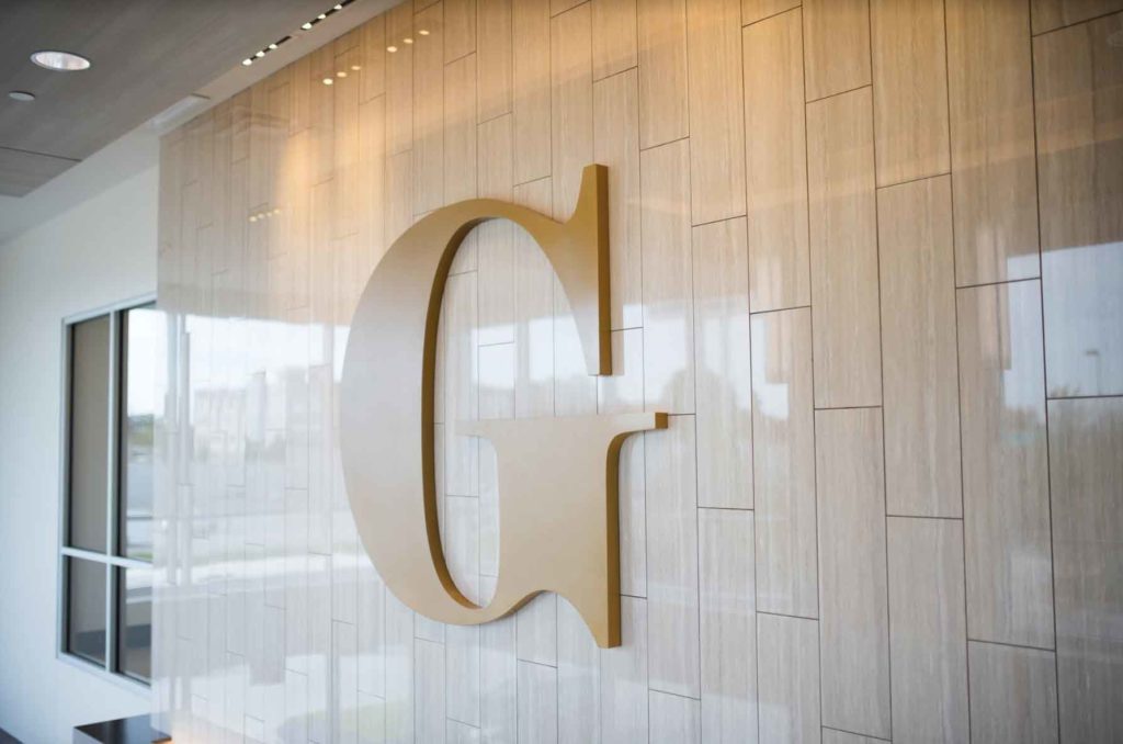 The big gold G on the wall in the office of Gordon McKernan Injury Attorneys