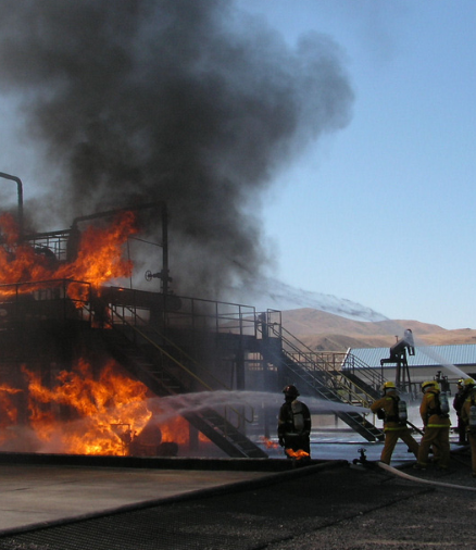 firemen putting out an industrial plant fire