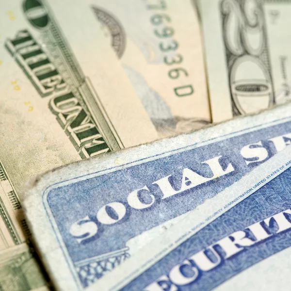 social security cards on top of money from social security benefits