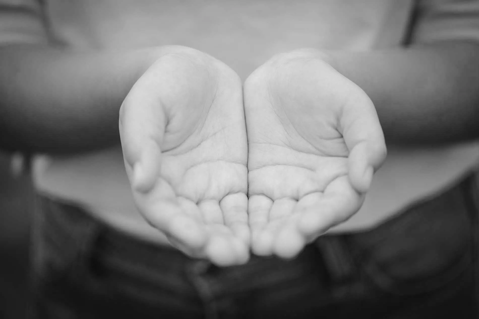 hands cupped together in black and white