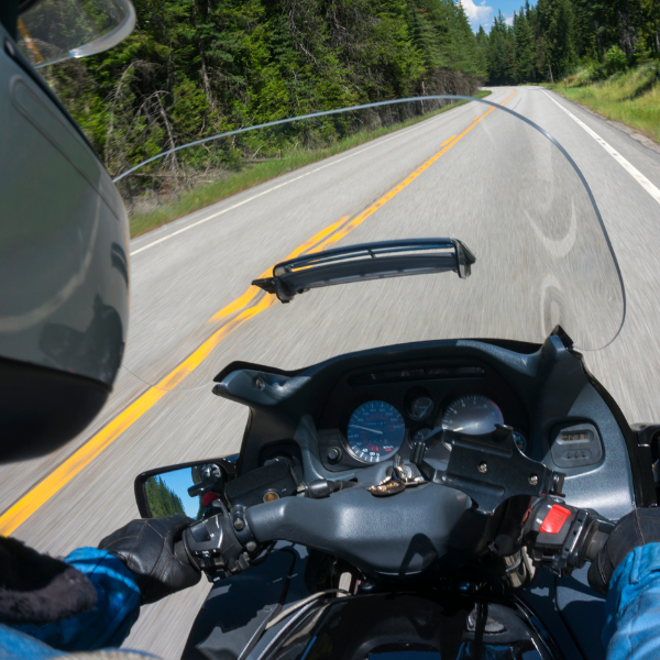 motorcyclist riding on a road