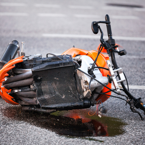 A damaged orange motorcycle lays on the ground following a motorcycle accident near Lafayette