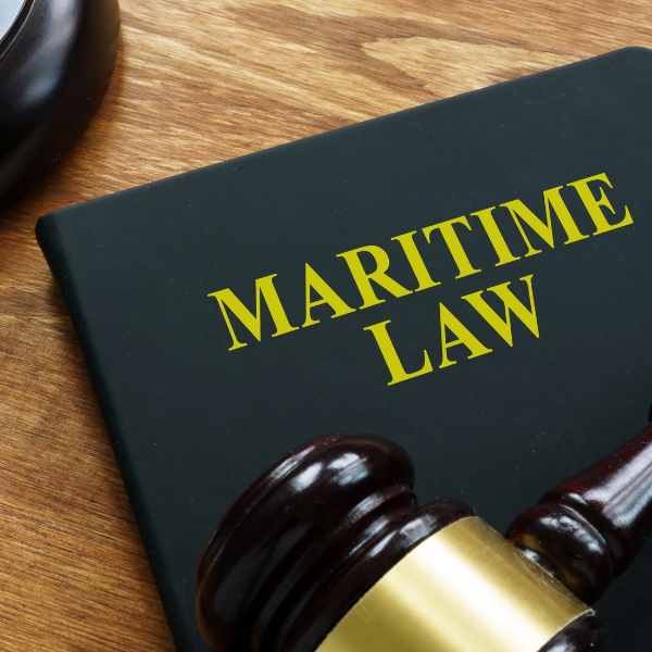 A lawyers gavel resting on a law book about maritime law