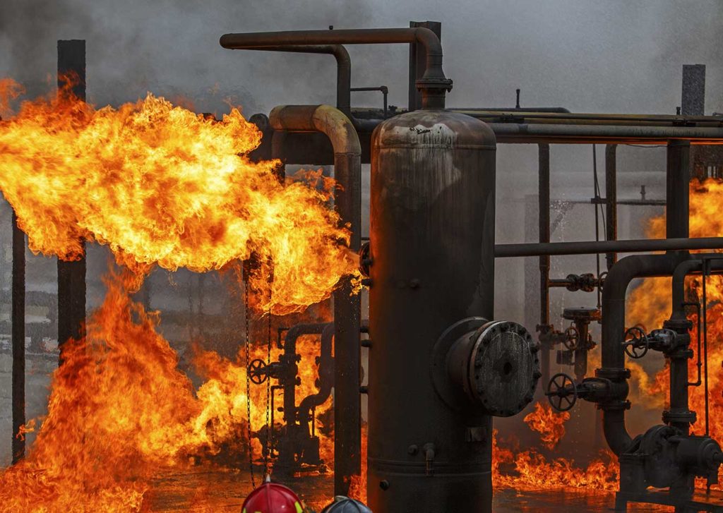 Flames surrounding pipes and valves following an explosion in Baton Rouge