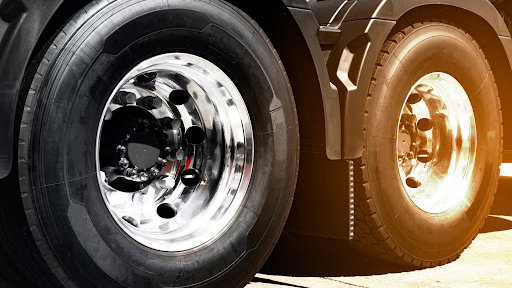A closeup of commercial truck tires shining in the sun