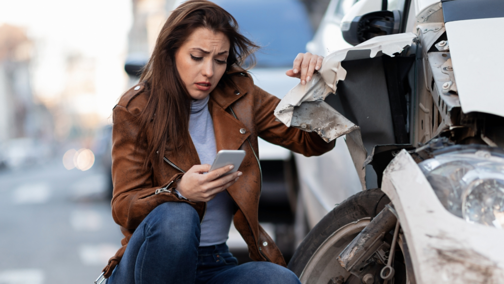 A woman looks distraught and calls for help after a an accident with a commercial truck