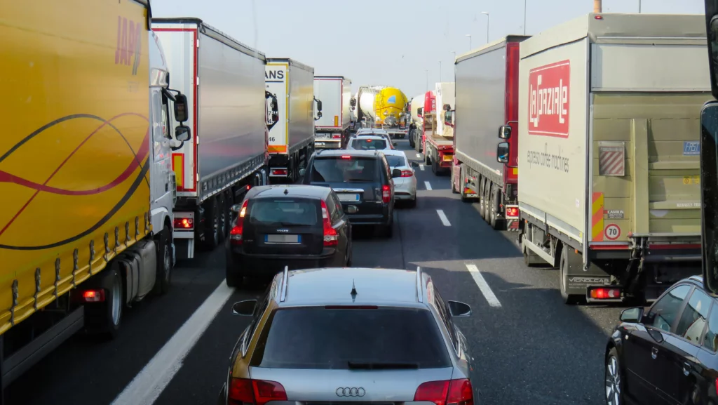 Heavy traffic on a highway in Monroe with cars in between many semi trucks