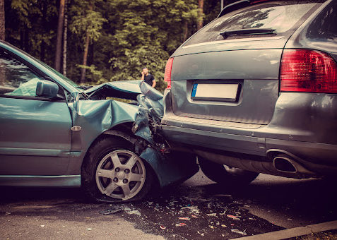 Two damaged cars in the street after a rear-end car accident