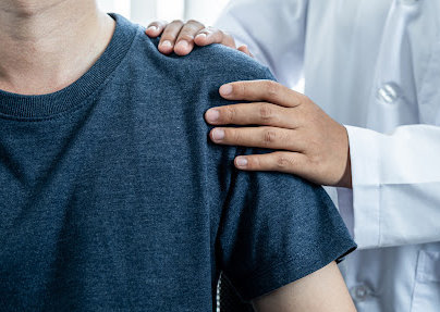 A doctor examines a Gonzales personal injury victim's shoulder.