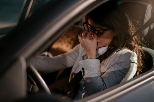 Driving tired like this woman is a type of cognitive distracted driving.