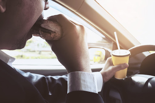 Eating while Driving like this man is a manual driving distraction.