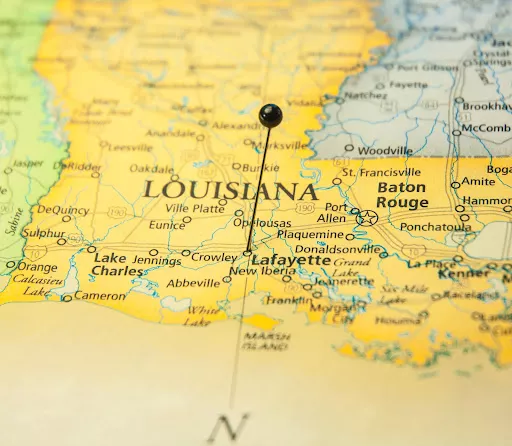 A map of  the state of Louisiana with a pin in it