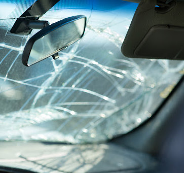 Broken and cracked windshield from a car accident