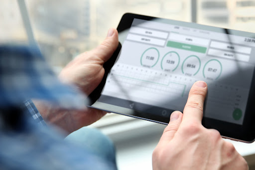 A trucker logs their hours on a tablet, as required by law.