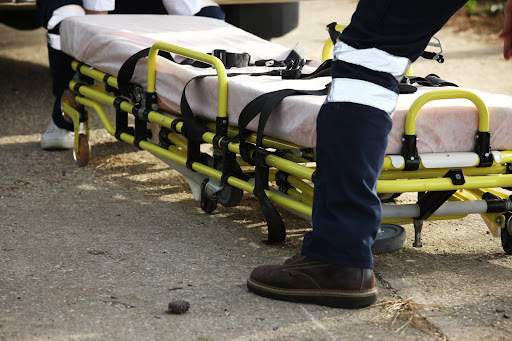 A paramedic laying out a spinal cord stabilizing gurney