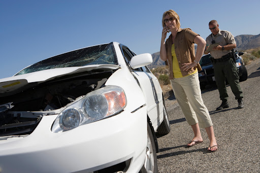 A woman and police officer survey the damage after a car accident in Shreveport.