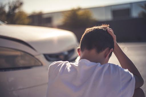 A young man thinks about what to do after a car accident in Denham Springs.