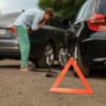 Car accident triangle in front of grey car and black car