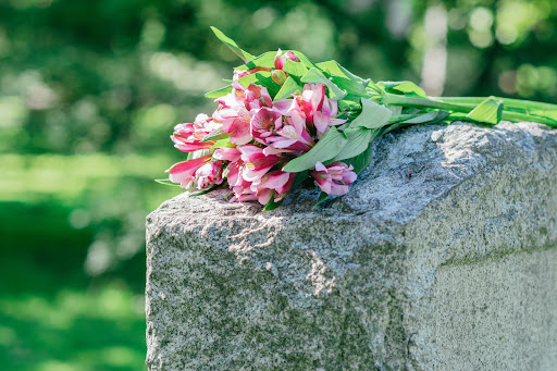Flowers on a tombstone, left by the family of a victim of a wrongful death in Lafayette.