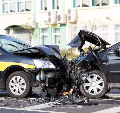 Severe damage to two cars after a head on car accident