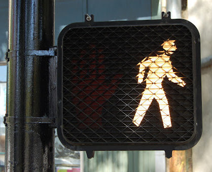An Illuminated walk sign for pedestrians in Louisiana.