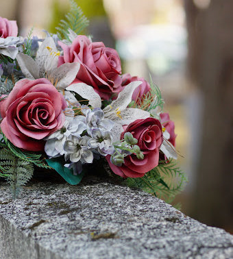 A bouquet of flowers laid on top of a gravestone in Gonzales, Louisiana.