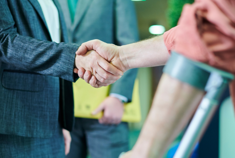 injured person shaking lawyer's hand