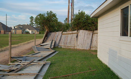 A wooden fence that has been knocked over by a hurricane in Louisiana.