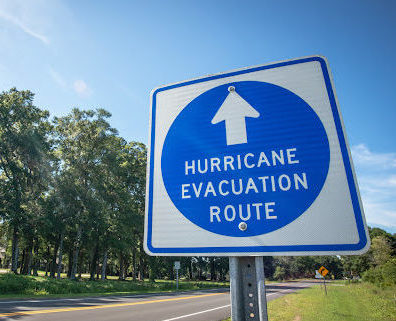 A blue and white sign indicating the hurricane evacuation route.