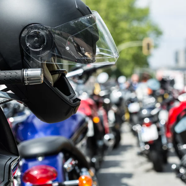 motorcycle helmet hanging from handlebar