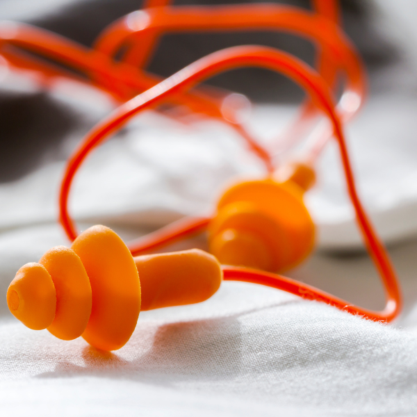 A closeup of a pair of orange earplugs.