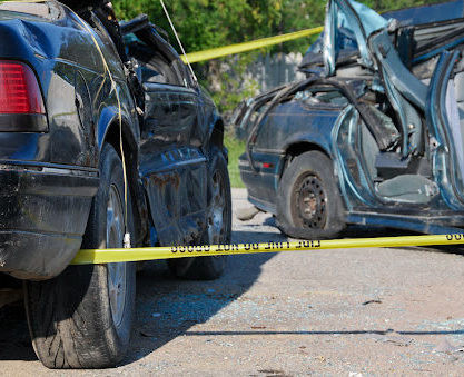 Two cars surrounded by caution tape after an accident in Louisiana.