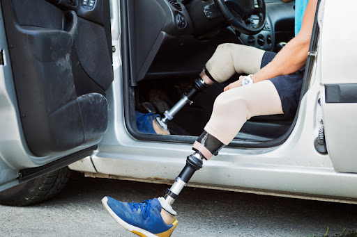 A double leg amputee getting out of their car