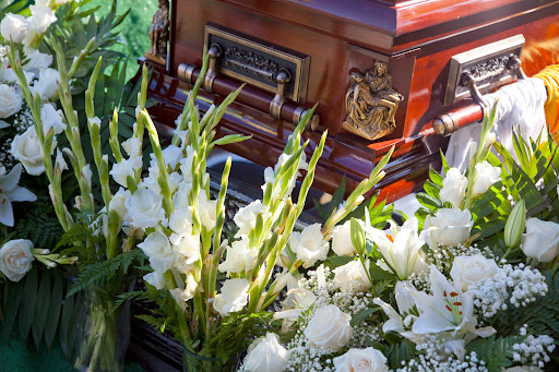 A coffin and funeral flowers.