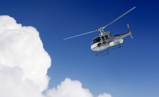 helicopter going down in the clouds and sky