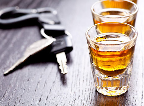 Car keys next to shots of alcohol