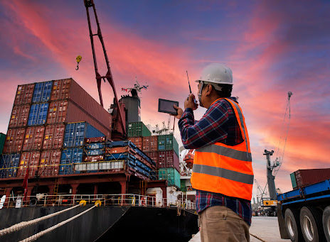 A dock worker directing a cargo ship into port in Shreveport