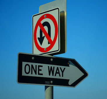 Traffic signs against a blue sky