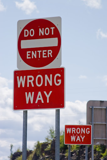 Numerous signs indicating the wrong way