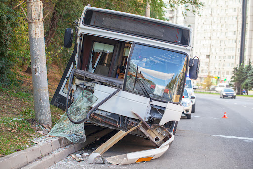 The smashed front end of a city bus after an accident