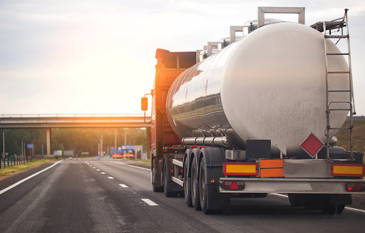 A semi truck carrying a dangerous chemical travels down a highway