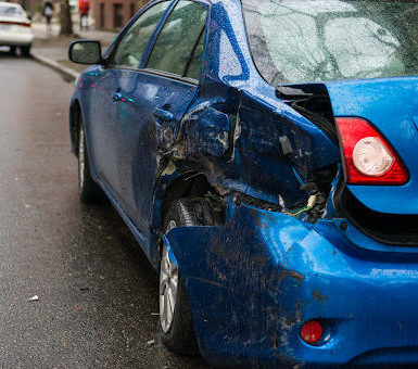 A parked car with damage from a hit and run accident