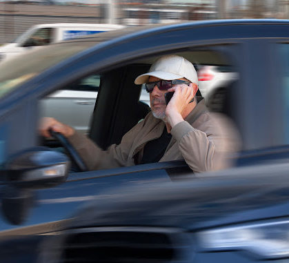 A reckless driver talking on their phone while driving