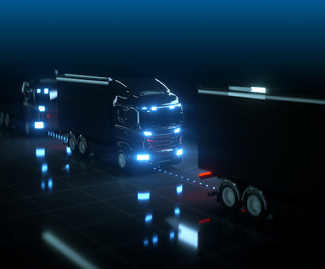 A futuristic concept of self driving trucks in the dark with sensors and lights glowing