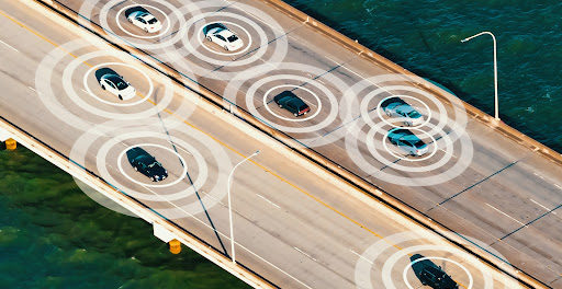 Multiple self driving cars driving over a bridge