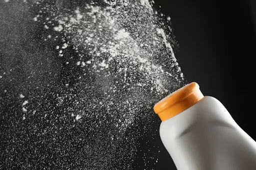 Talcum powder in the air against a black background