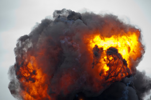 Flames and smoke from an explosion at a hazardous waste disposal facility