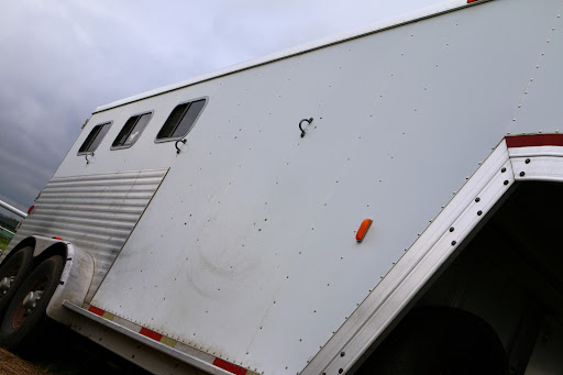 The exterior of a white horse trailer