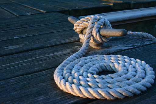 A thick rope coiled up on a dock near Zachary, Louisiana