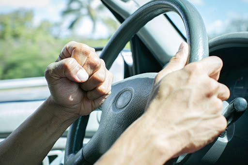 A driver honks their horn aggressively while driving